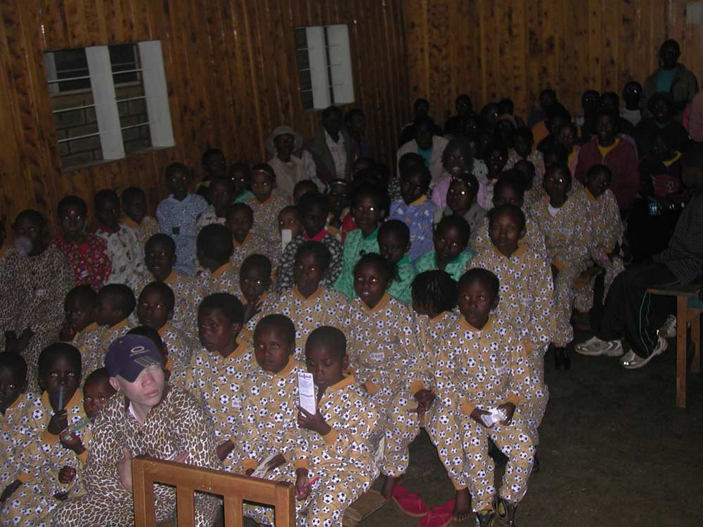 Young children enjoying their first ever movie in their new pajammas donated by the hopes and dreams team